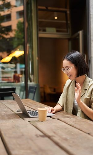 portrait-asian-woman-looking-laptop-video-chat-talking-with-someone-via-computer-camera-sitting-cafe-drinking-coffee-online-meeting